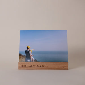 A Wooden photo holder with Our Happy Place engraving. A Perfect Gift. Made in St Ives Cornwall.